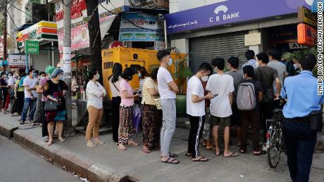 Residents in Yangon line up in front of an ATM machine of a closed bank on February 1, 2021.