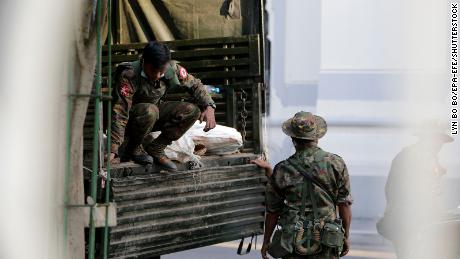 Military soldiers move bags from a truck into Yangon City Hall, in Yangon, Myanmar,  February 1, 2021. 