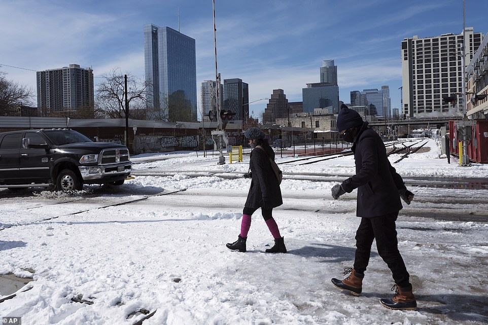 Austin, Texas: People walk on snowy streets Tuesday. Temperatures dropped into the single digits in the state Tuesday