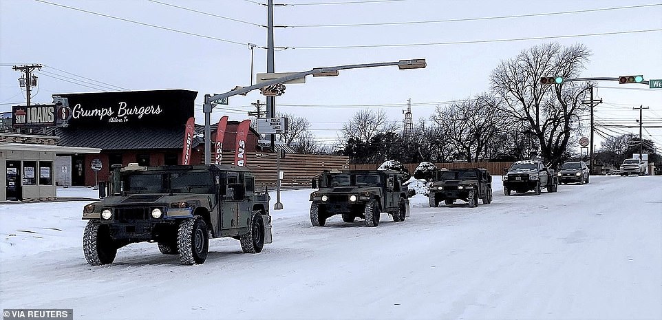Abilene, Texas: Military vehicles from the Texas Military Department of the Texas National Guard, tasked to transport residents to designated warming centers and other required duties, form a convoy