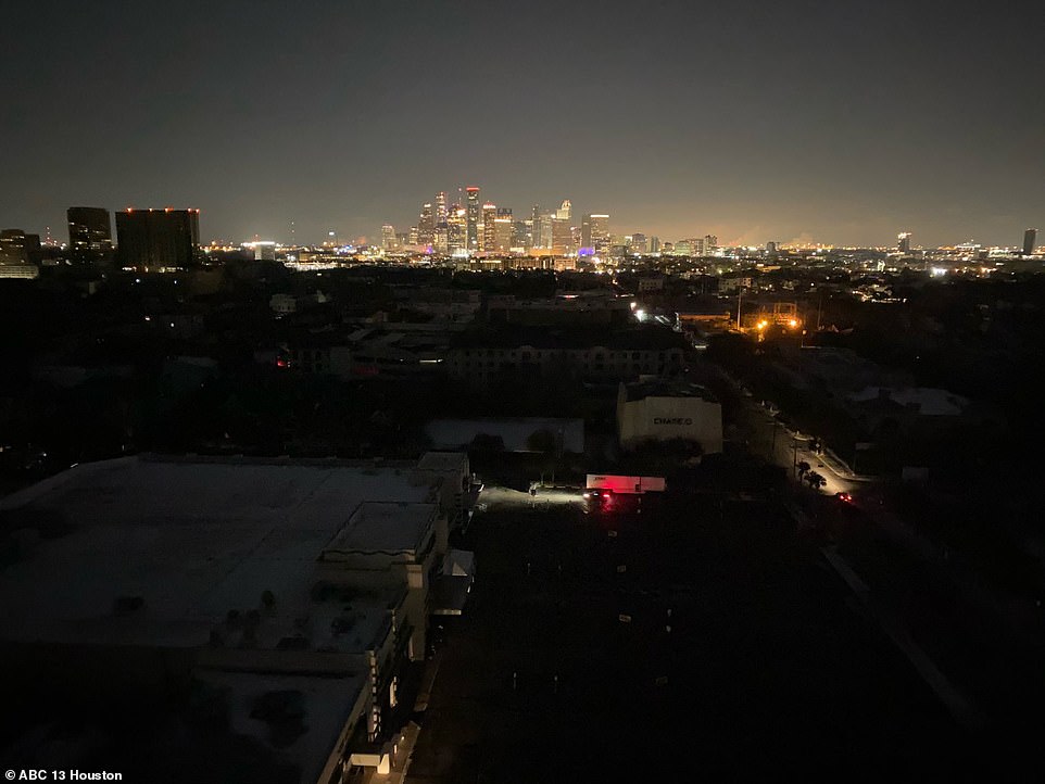The deep freeze has paralyzed Texas by knocking out its power grid. Pictured are homes in Houston without power but empty offices still lit up