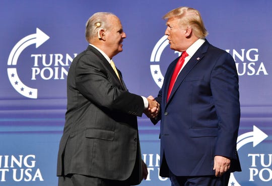 Friends and mutual admirers Rush Limbaugh and President Donald Trump greet each other during the Turning Point USA Student Action Summit at the Palm Beach County Convention Center in West Palm Beach, Fla., on Dec. 21, 2019.