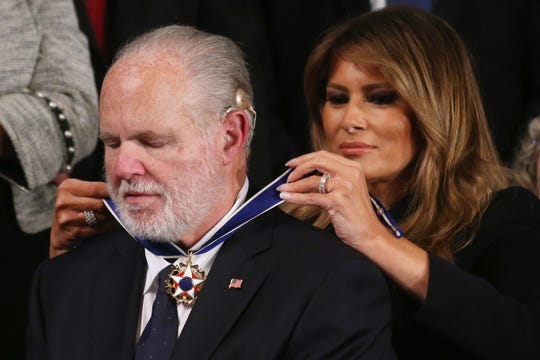 First lady Melania Trump fastens the Presidential Medal of Freedom awarded to Rush Limbaugh during the State of the Union address in the House of Representatives on Feb. 4, 2020.