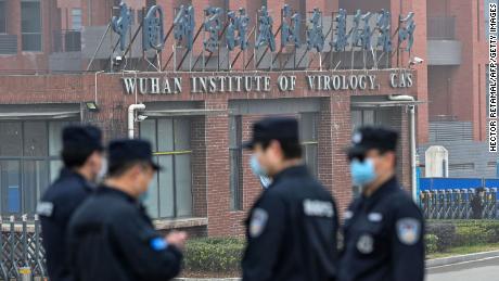 Security personnel stand guard outside the Wuhan Institute of Virology in Wuhan as members of the World Health Organization team make a visit.