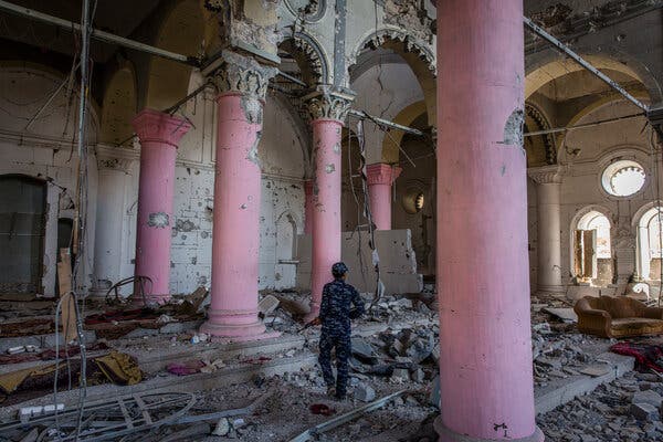 An Iraqi police officer walking through the bombed-out ruins of a centuries-old church that the Islamic State used for its occupation in Mosul’s Old City.