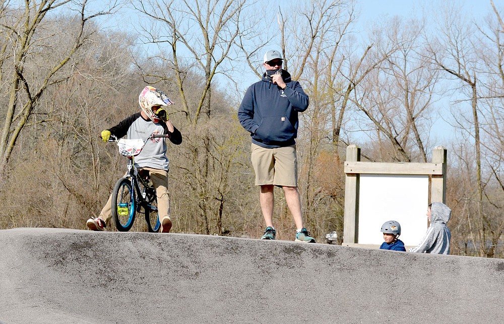 Marc Hayot/Herald-Leader Parks and Recreation Manager Jon Boles (right, with cyclist James Stevenson) looks over the bicycle courses at City Lake Park before the start of Spring Break Bike Fest. The event which occurred on the first day of Spring gave people a chance to come outside for some fresh air and fun.