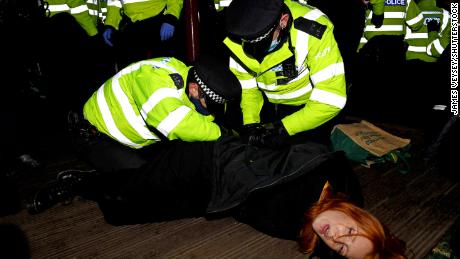 A woman is arrested at a vigil on Saturday in memory of murdered Londoner Sarah Everard.