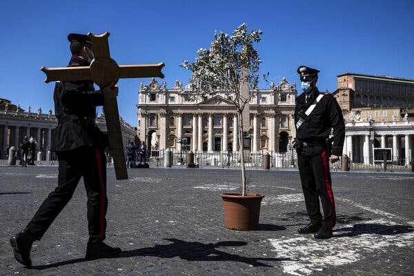 The usual crowds of Easter pilgrims were kept from gathering in St. Peter’s Square in Vatican City for a second year because of coronavirus precautions. Police officers placed a cross with an olive tree in the square on Sunday.