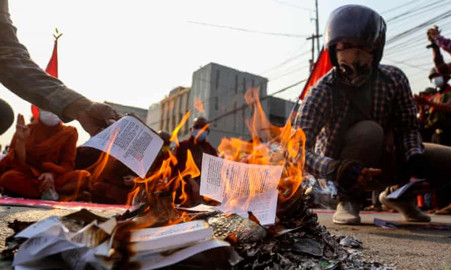 Protesters burn a copy of Myanmar’s constitution in Mandalay