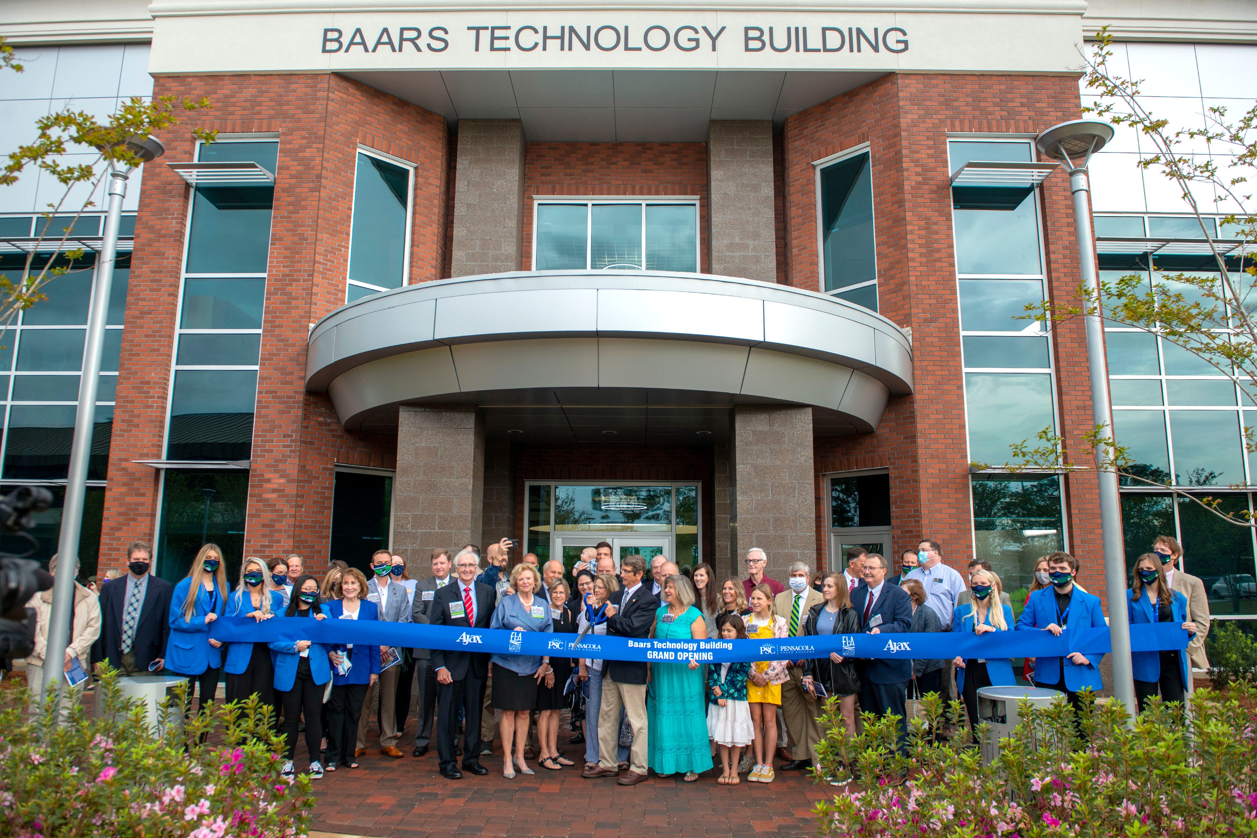 Theo Baars III gets ready to cut the ribbon Friday on the new Baars Technology Building at Pensacola State College.