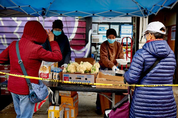 People wait in line at a food pantry in New York on Monday. Economists expect jobless claims for the foreseeable future to remain much higher than they were before the pandemic.