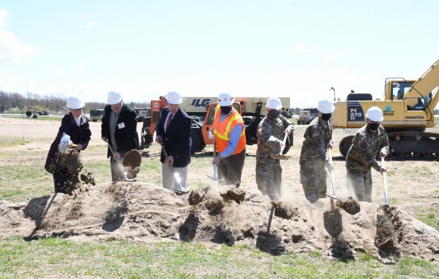 Participating in a ground-breaking ceremony May 12 for a new unmanned aircraft system (UAS) hangar at Wheeler-Sack Army Airfield were Pam Favre, Fort Drum Public Works master planner; Dave McNeil, QPK Design engineer of record; Bill Halsey, Structural Associates Inc. president; Reinhard Koenig, U.S. Army Corps of Engineers regional business director for North Atlantic Division; Col. Jeffery Lucas, Fort Drum garrison commander; Col. Travis McIntosh, 10th Combat Aviation Brigade commander; and Command Sgt. Maj. Roberto Munoz, Fort Drum garrison senior enlisted adviser. (Photo by Mike Strasser, Fort Drum Garrison Public Affairs)