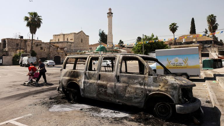 A burnt vehicle is seen after violent confrontations in the city of Lod, Israel between Israeli Arab demonstrators and police, amid high tensions over hostilities between Israel and Gaza militants and tensions in Jerusalem May 12, 2021