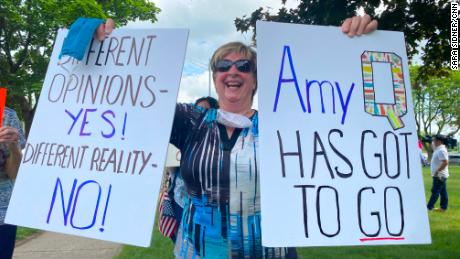 Protesters made signs calling Fachinello &quot;Amy Q&quot; because of the controversy surrounding her QAnon-related posts.