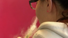 A female using a vaping device.