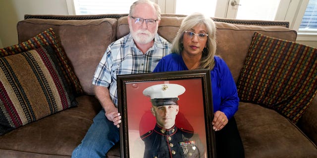 Joey and Paula Reed with a portrait of their son, Marine veteran and Russian prisoner Trevor Reed, at their home in Fort Worth, Texas, Feb. 15, 2022.