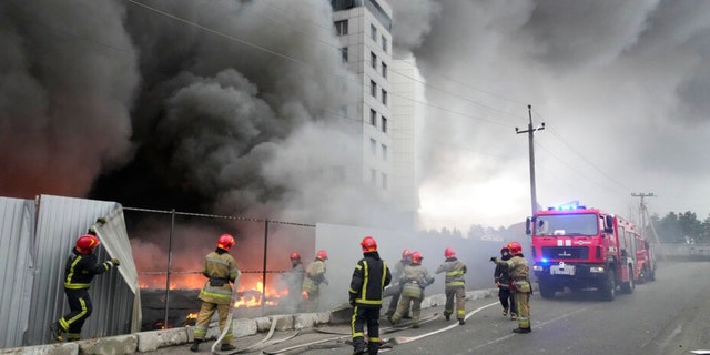 Firefighters work to extinguish a fire at a damaged logistics center after shelling in Kyiv, Ukraine, March 3, 2022.