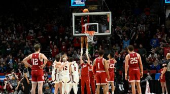 Indiana basketball cheerleaders retrieve ball in March Madness action