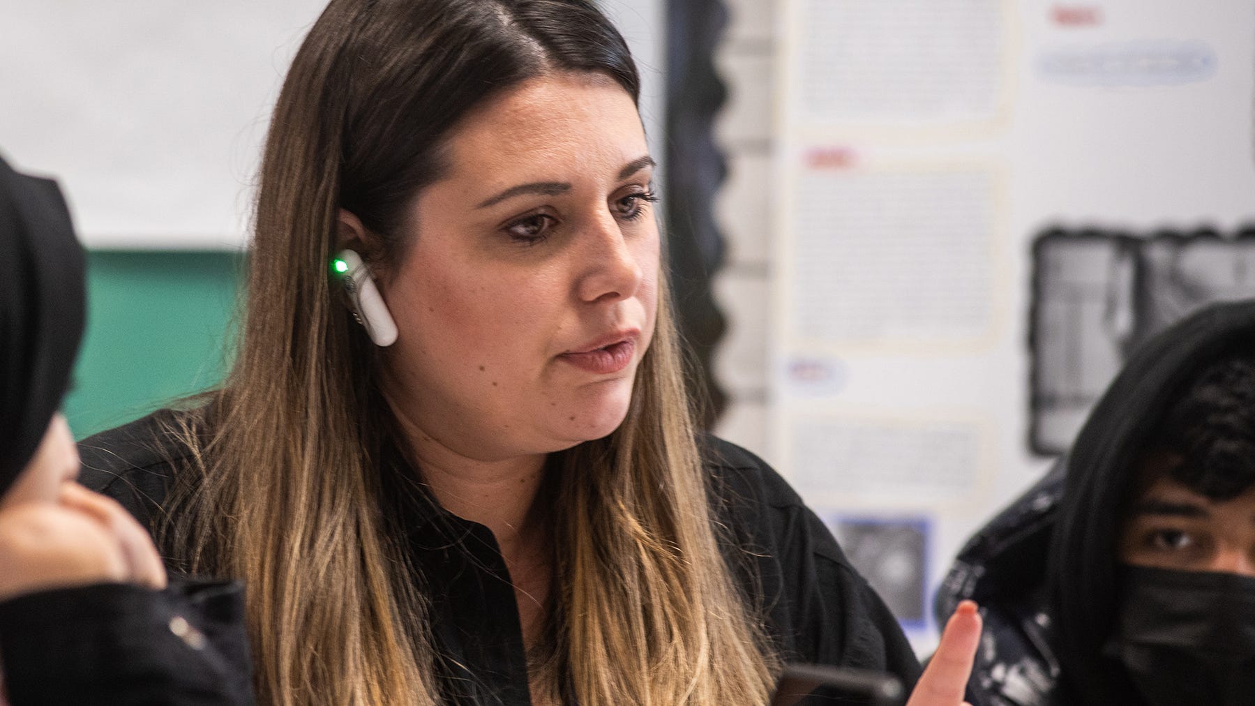 South Middle School social studies teacher Alyssa Cruz converses with her students with the help of the Timekettle WT2 translation device in her ear.