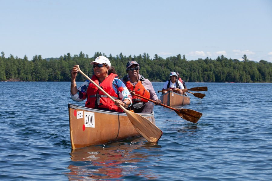 Canoeists paddle with Outdoor Afro.