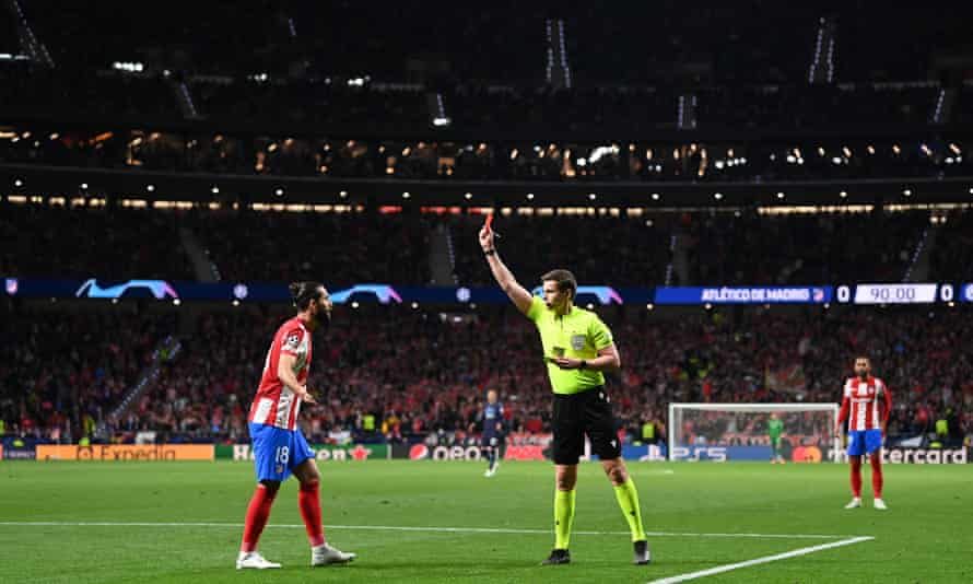 Referee Daniel Siebert gives Felipe of Atletico Madrid a red card.
