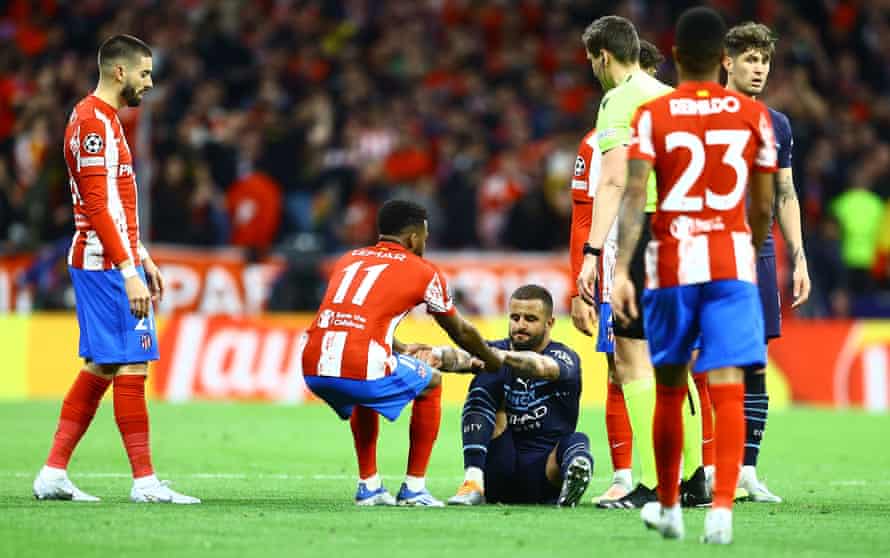 Kyle Walker of Manchester City is helped up Thomas Lemar of Atletico Madrid.