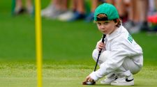 Apr 6, 2022; Augusta, Georgia, USA; Tommy Fleetwood talks with his son, Frankie, 4, on the no. 5 green during the Par 3 Contest at The Masters golf tournament at Augusta National Golf Club.