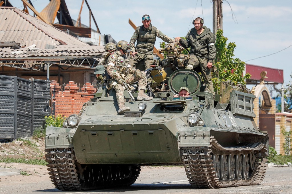 Russian troops on top of an armored vehicle in Mariupol on May 11, 2022.